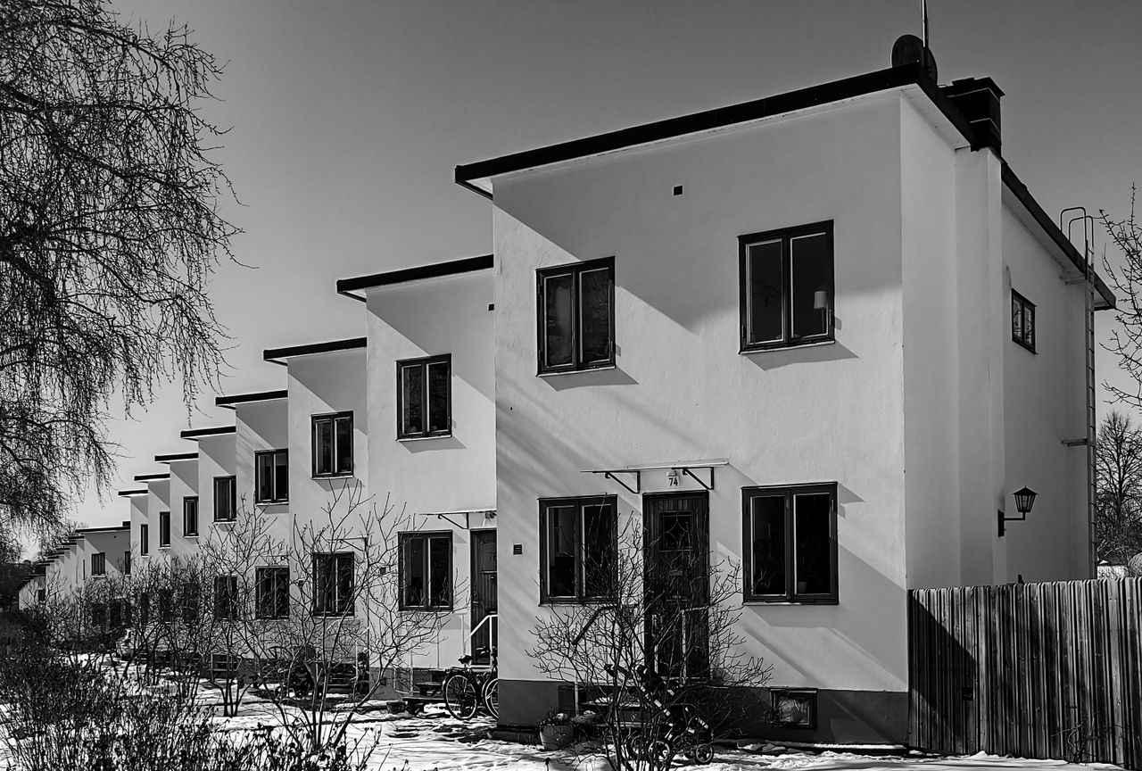 %titre de l'article% Rangée de maisons mitoyennes accolées partageant des murs communs